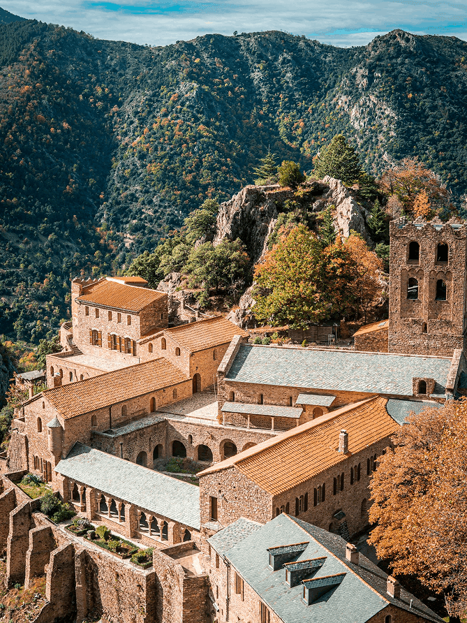 an airplane flying in the sky over a building
