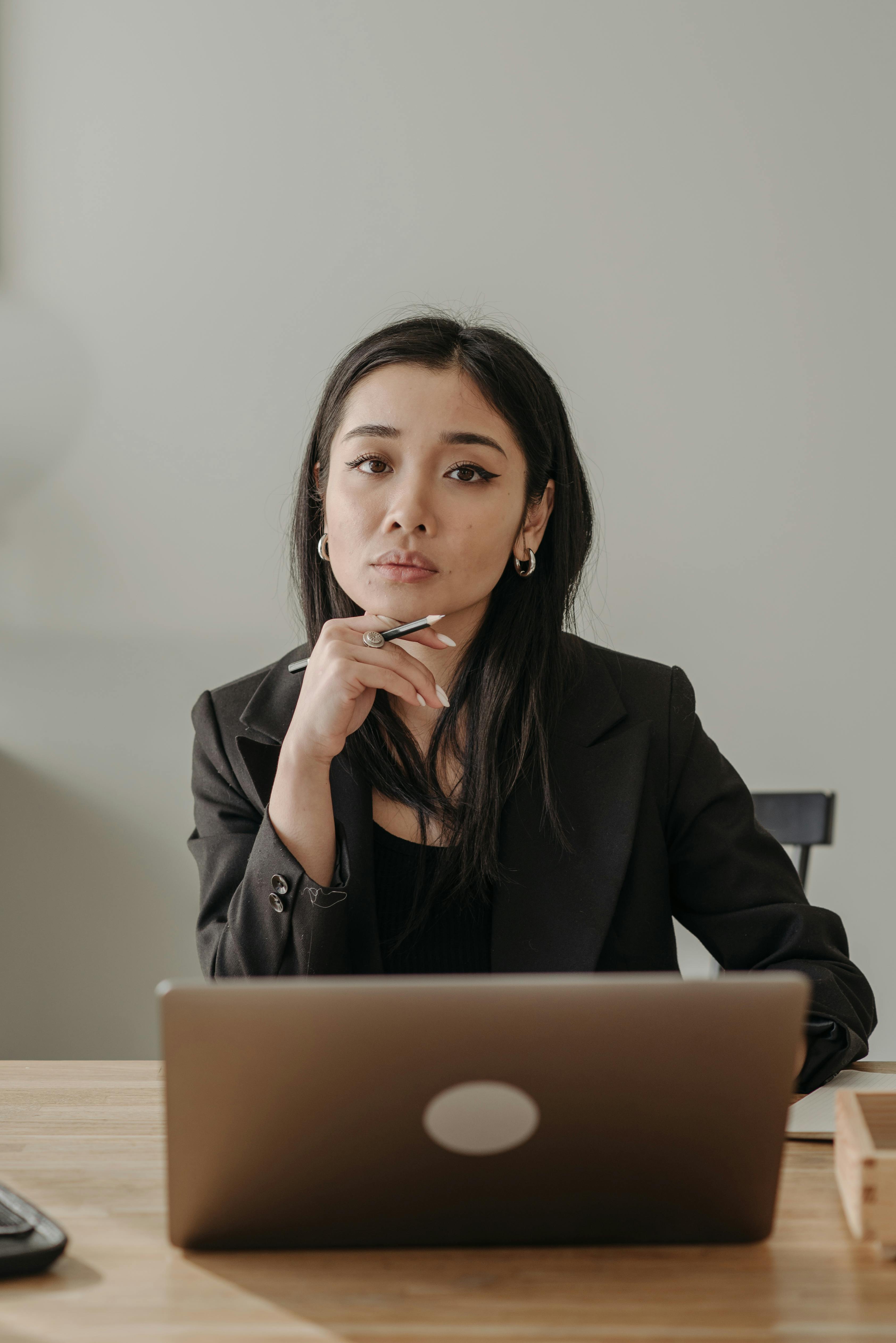 woman sitting around table holding tablet