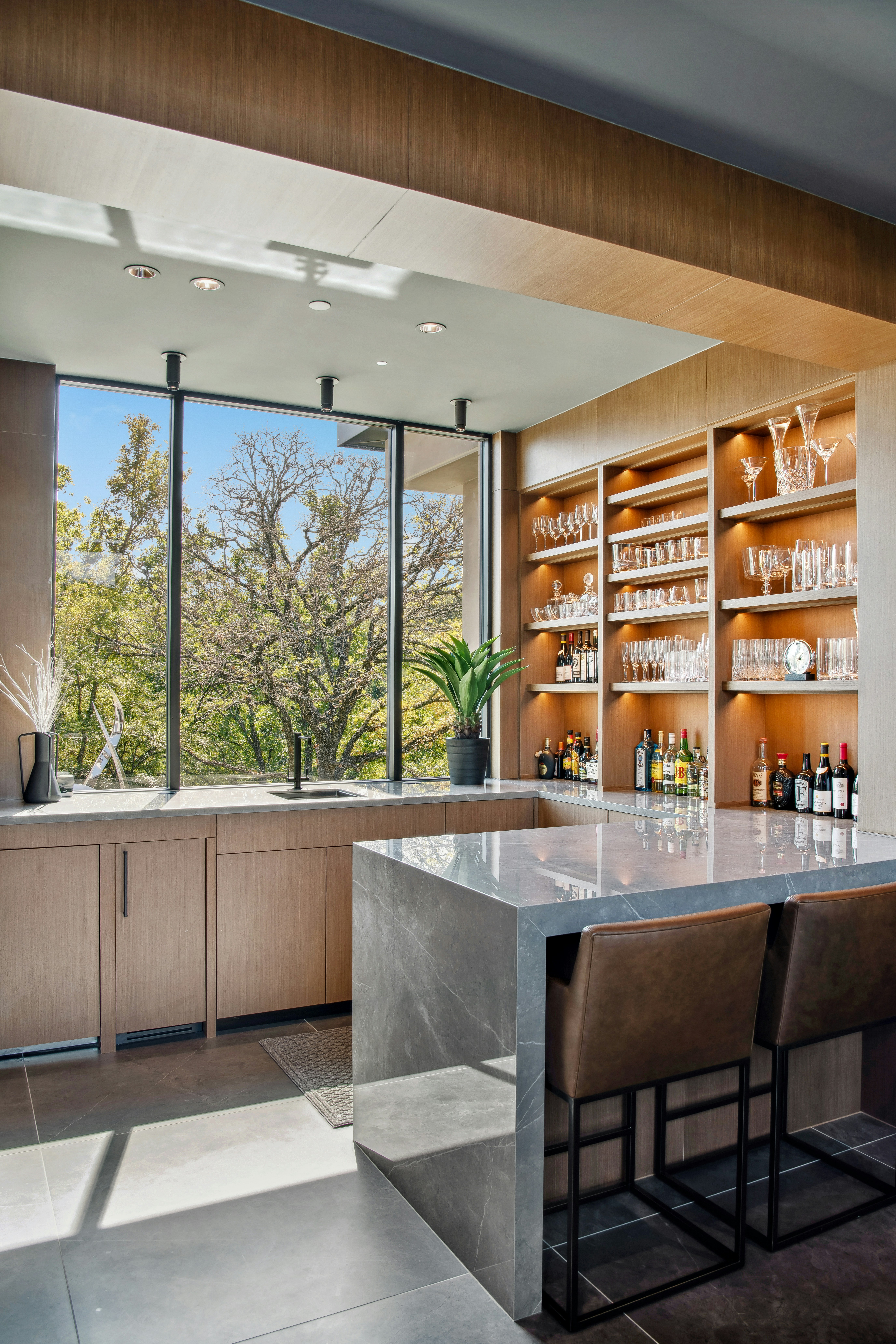 Modern home bar with extensive liquor and glassware
