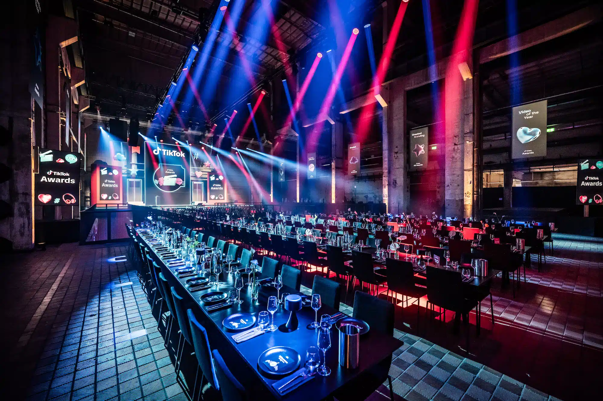 TikTok Awards – festively laid gala dinner tables in front of the main stage with dramatic stage lighting and TikTok Awards branding