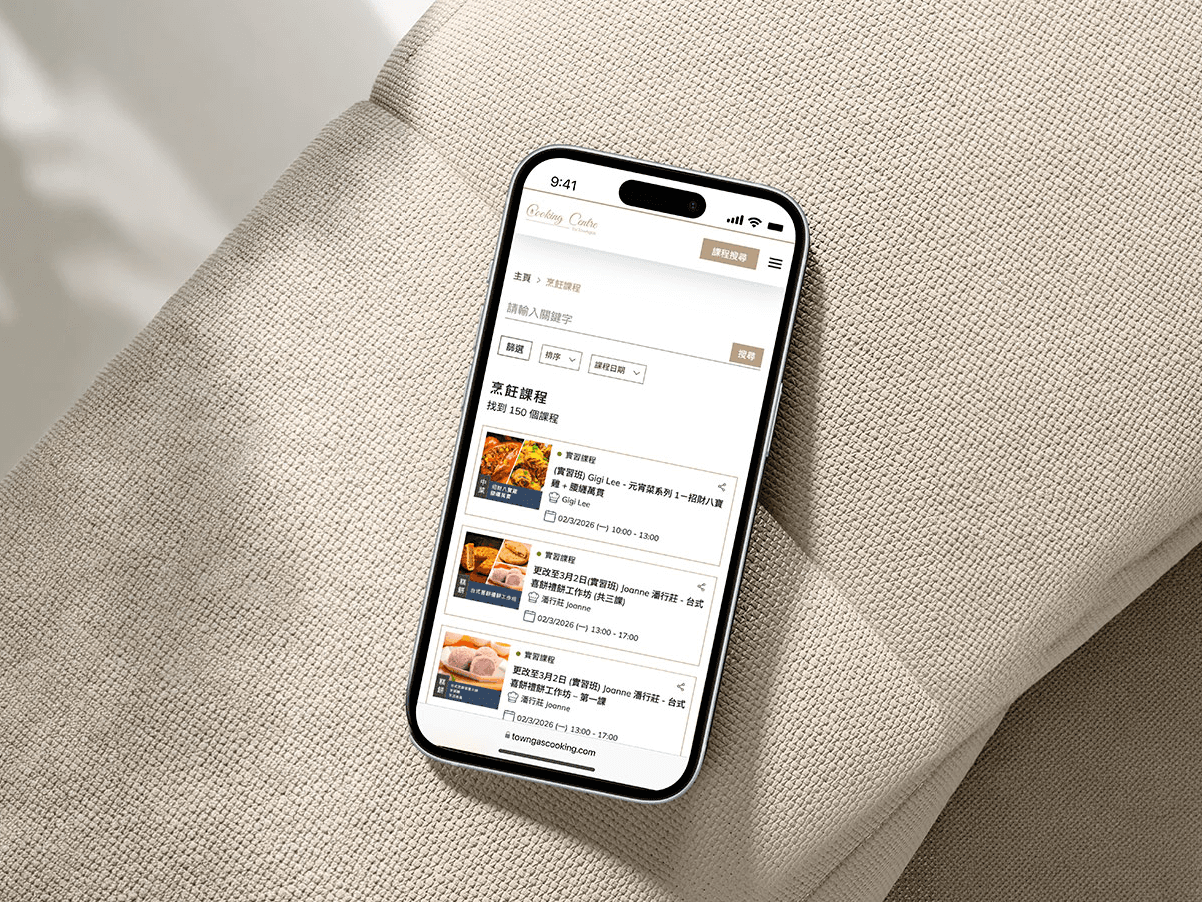 Close-up of hand holding pink ice cream cone against pastel background