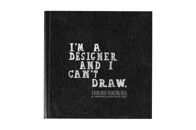 A black hardcover book with a textured cover displays the title "I'M A DESIGNER AND I CAN'T DRAW." in white, bold, sans-serif font. Below the title, in a smaller font, it reads "A BOOK ABOUT VISUALIZING IDEAS" followed by "BY MARIANA UCHOA SANTA CRUZ." The cover has a slightly distressed or worn appearance.