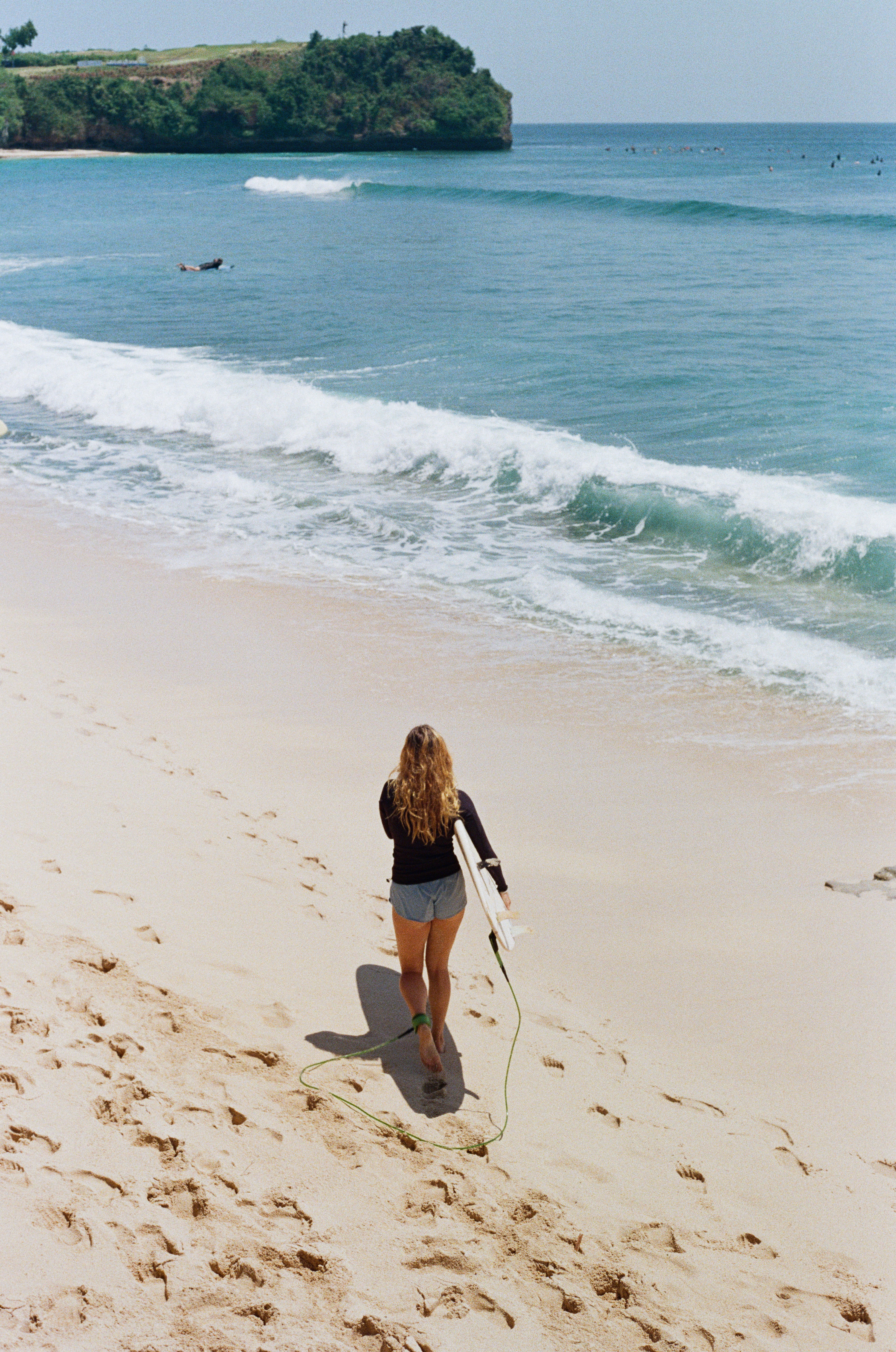 film photography of the surfer girl on the beach in Bali Balangan