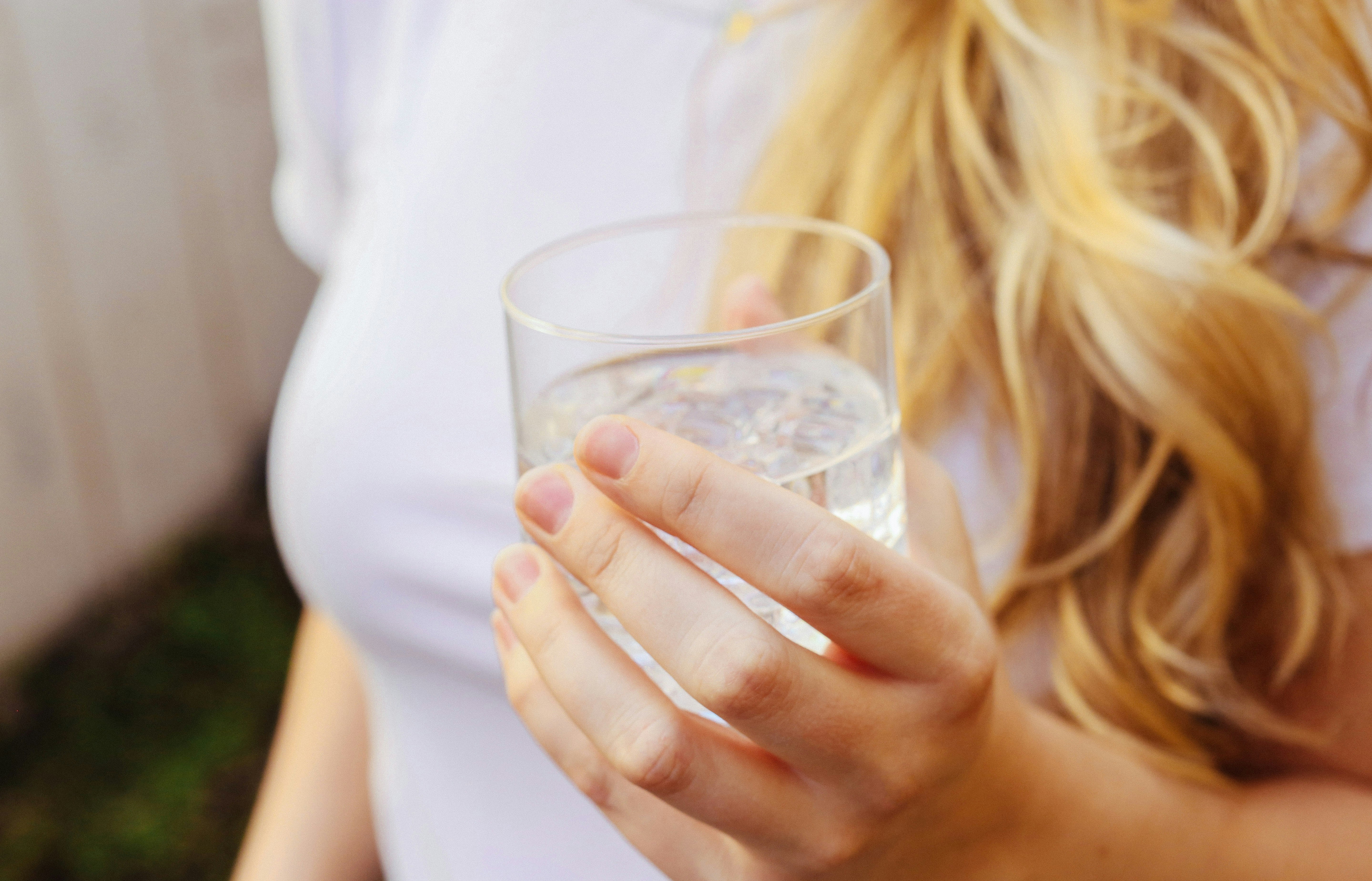 woman with glass of water - Skincare For Combination Skin