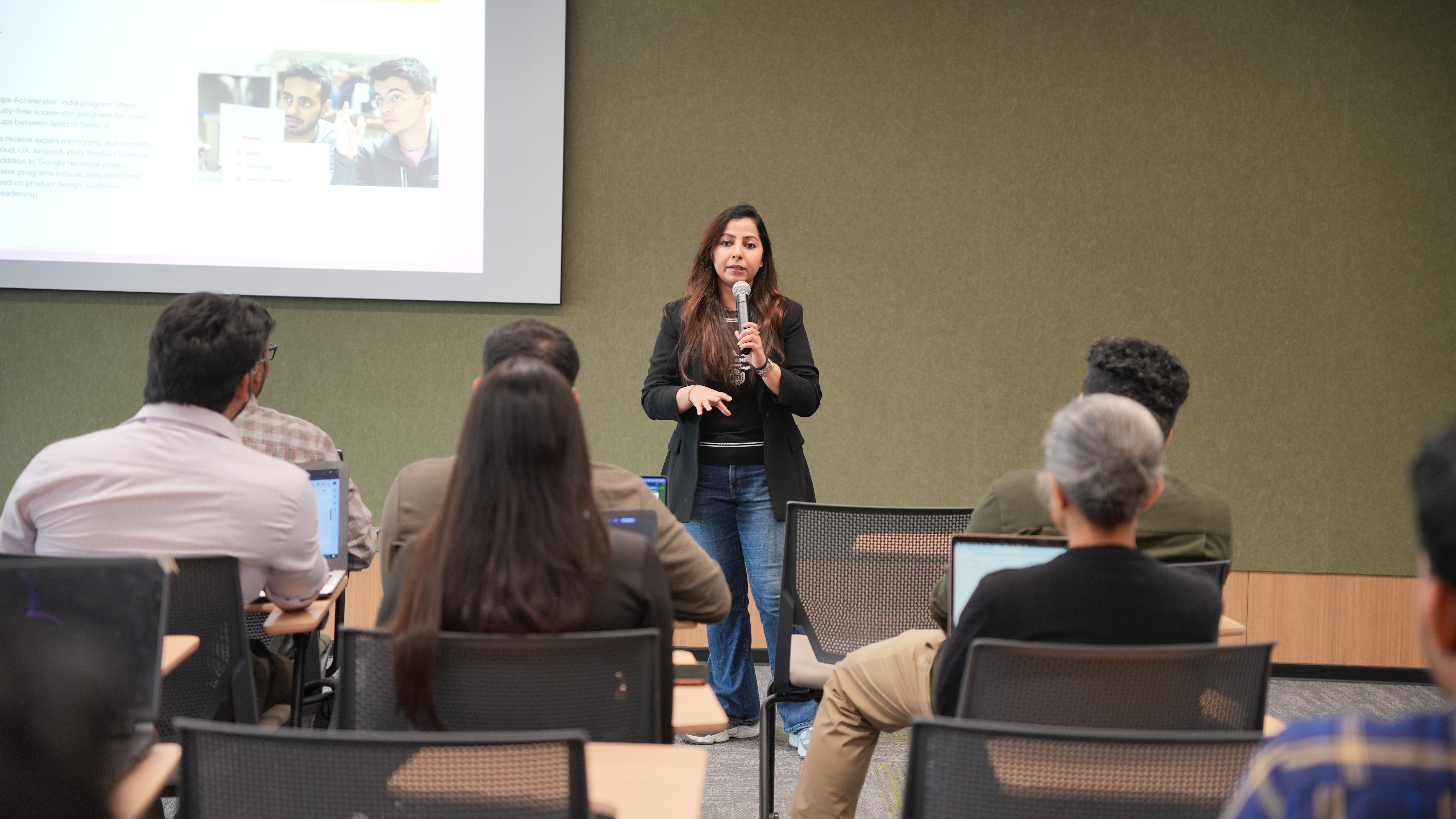 A man stading with Surfboard