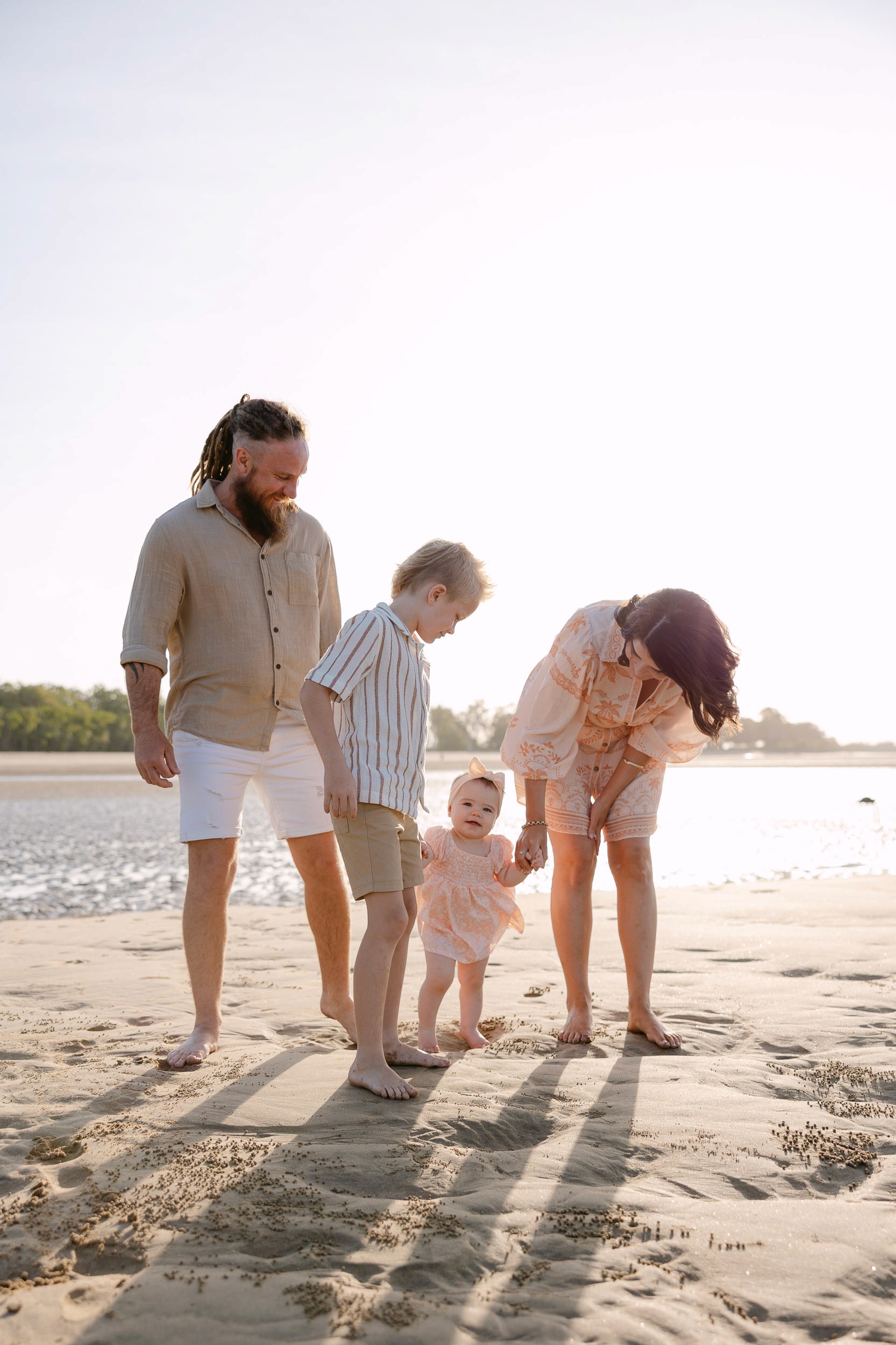 Parents and children playing together at the beach in Mackay