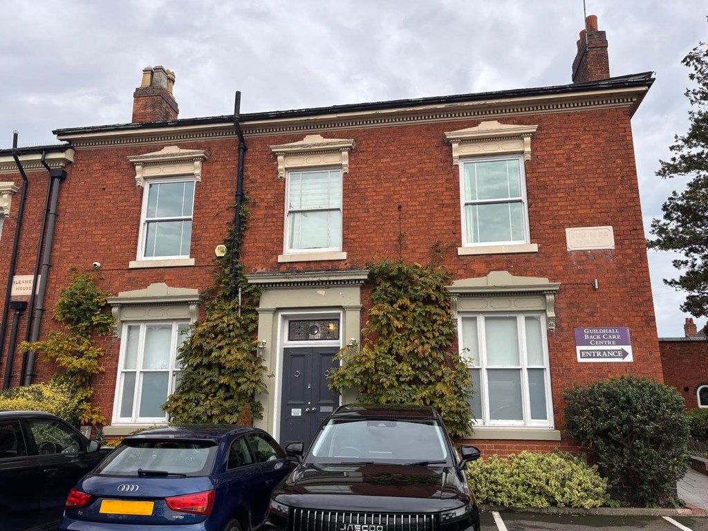 rusted private dermatology clinic entrance in Birmingham, located in a classic red brick professional building with onsite parking.