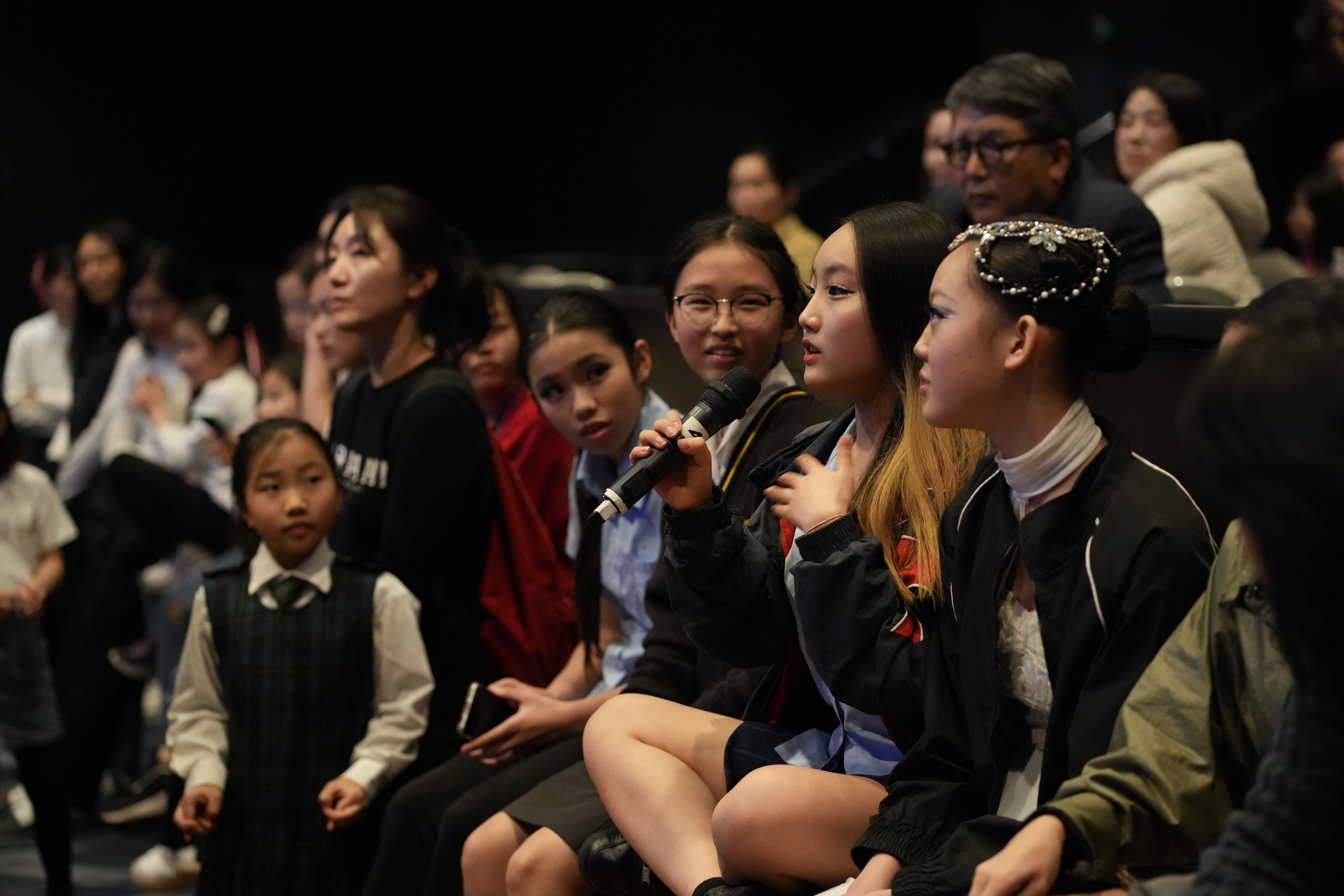 Curly haired woman holding smartphone.