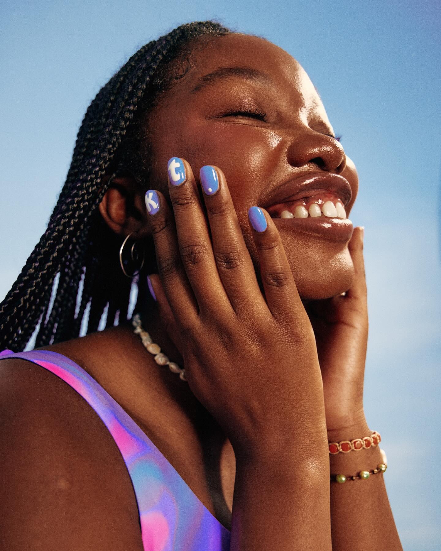 young lady holding her face and smiling