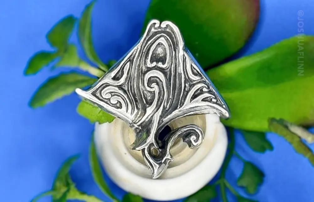 photograph of a cast silver pendant of a polynesian ray