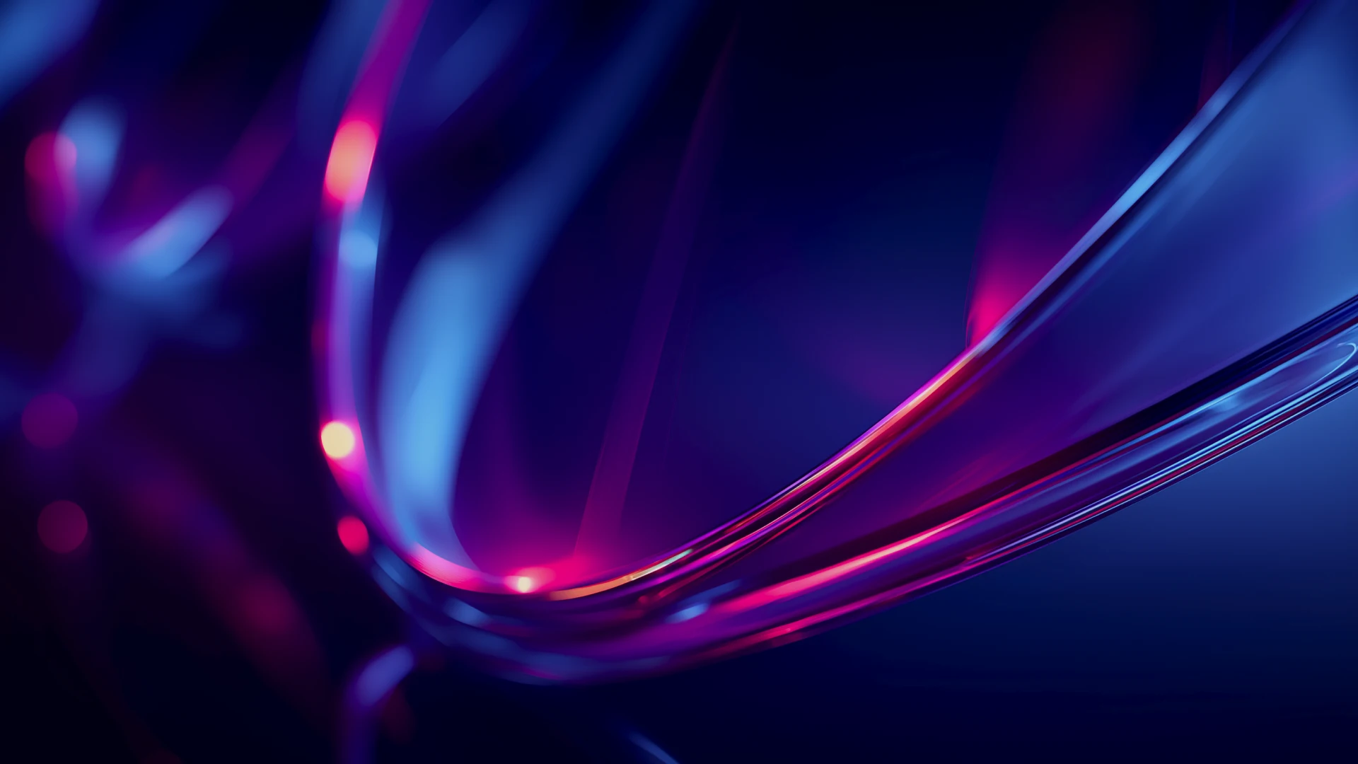 Abstract image of swirling blue and pink light trails against a dark background, creating a dynamic, fluid motion effect.