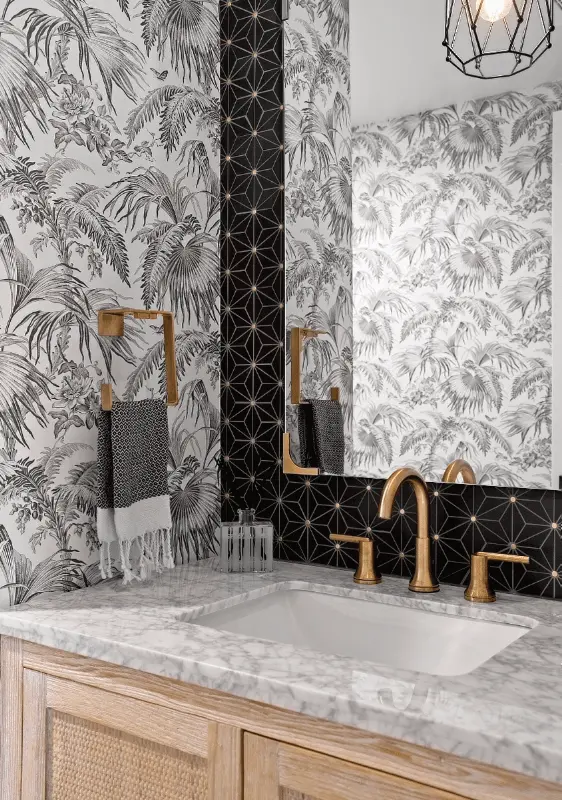 Portrait image of the powder bathroom vanity, featuring the sink and design elements in the Dana Point Remodel. Photo by Todd Huge.