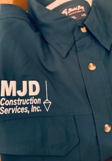 green grass field near lake under white sky during daytime
