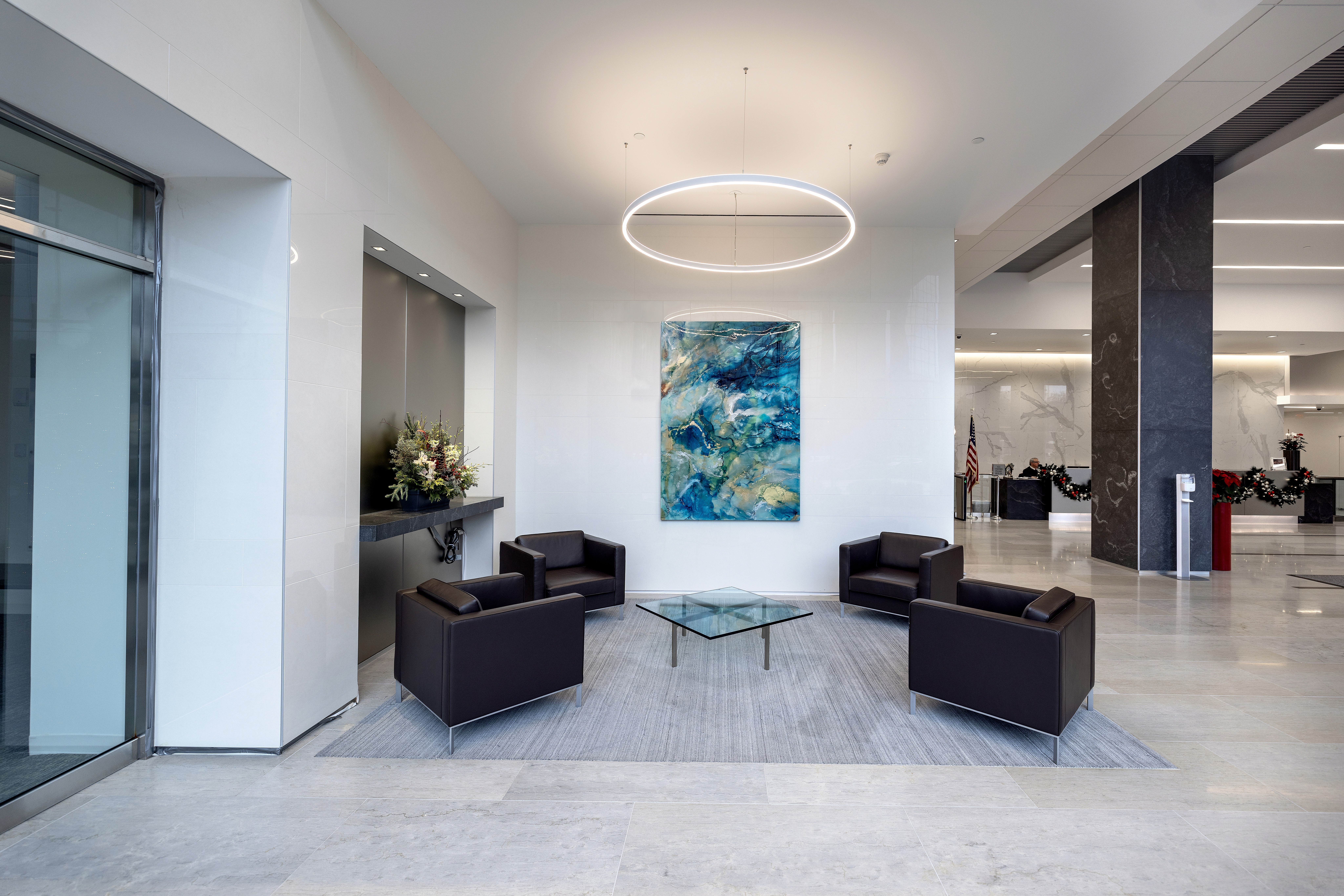 A woman observes framed black-and-white photographs in warm golden light