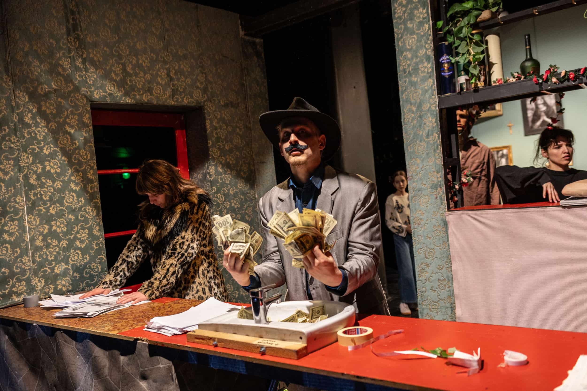 A green butterfly rests on a flower.