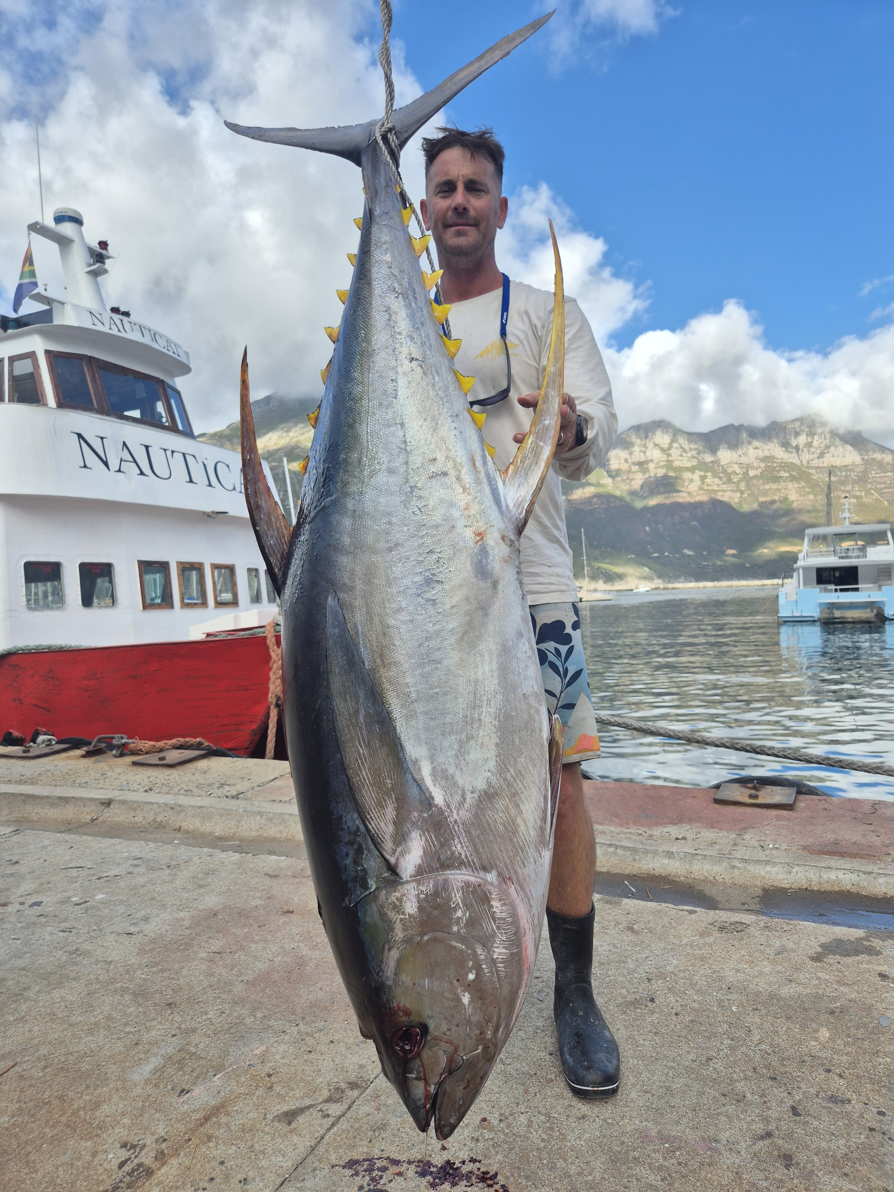 Fishermen celebrating a successful catch on a Salt Safari charter.