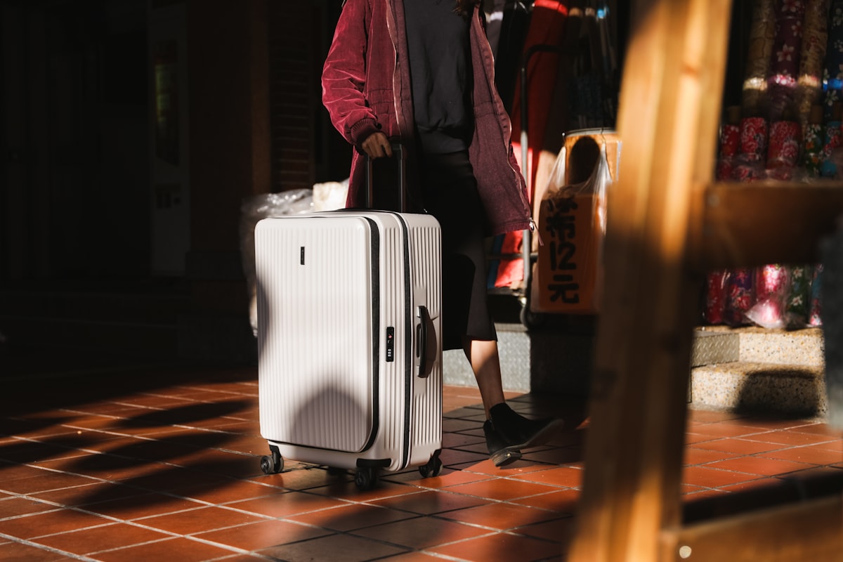 Traveler walking through an airport with a single carry-on bag