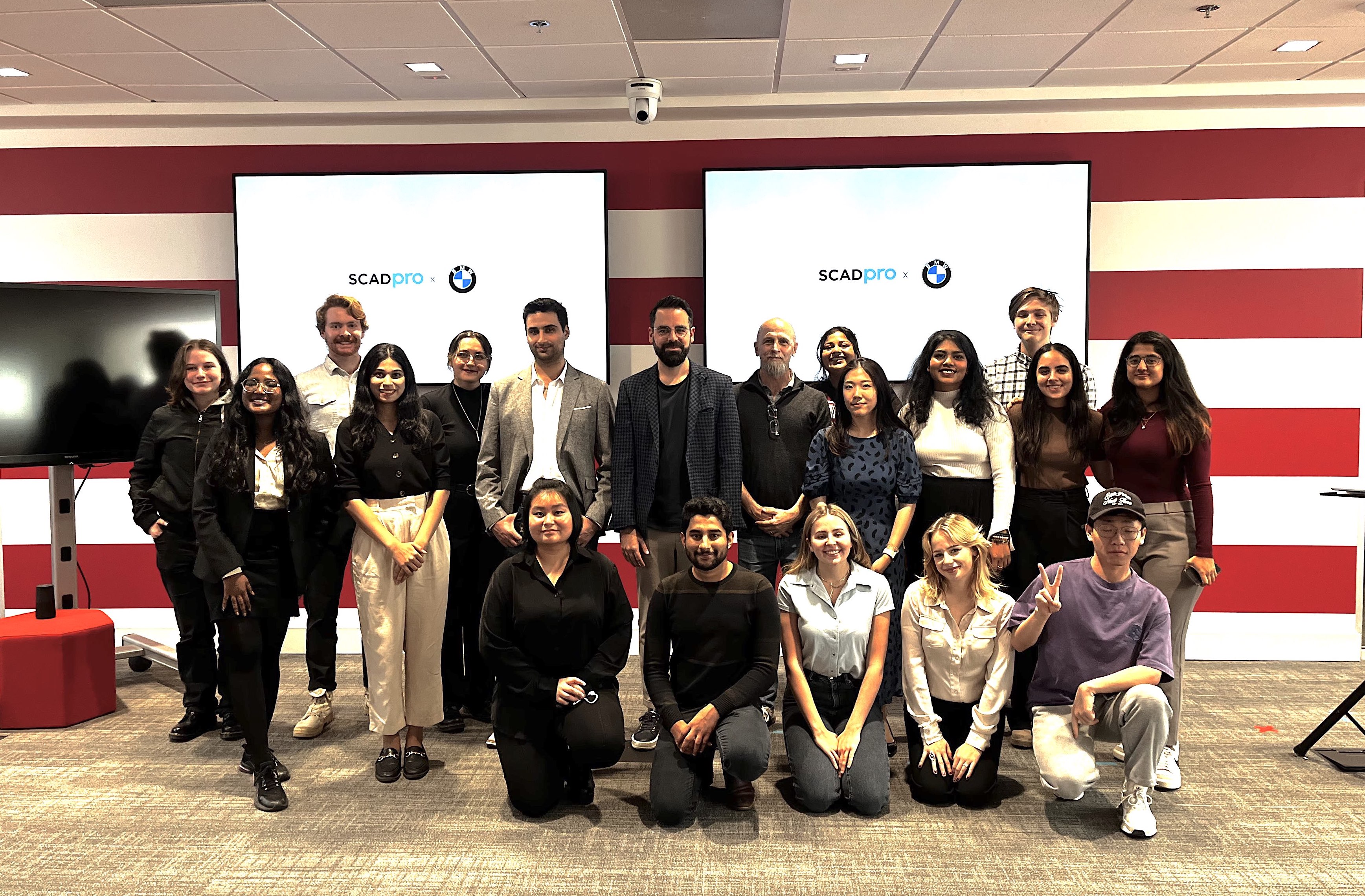 Modern home office setup with a monitor, ergonomic chair, keyboard, and indoor plants near a window with blinds.