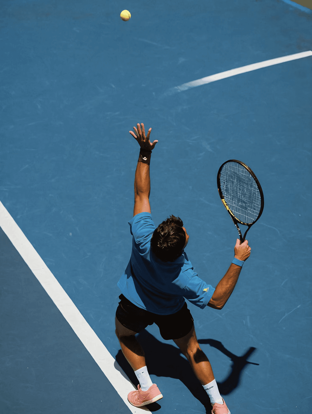 Man throwing tennis ball upwards