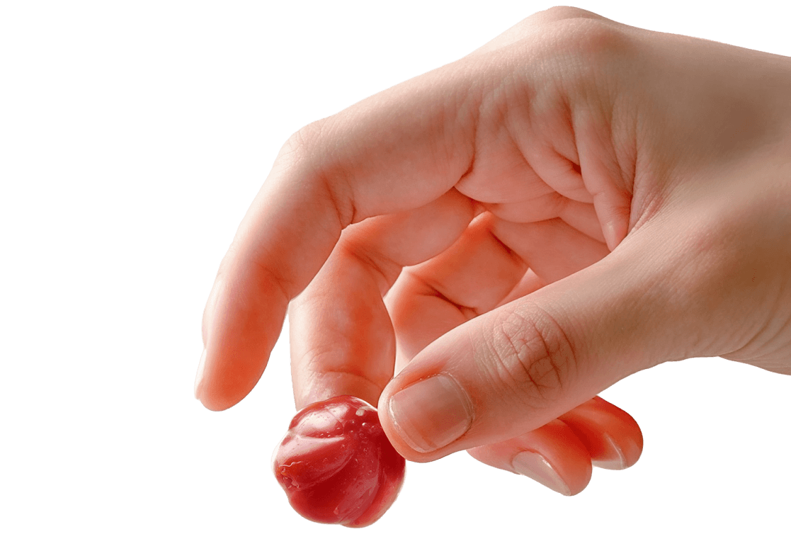 a hand holding a gummy