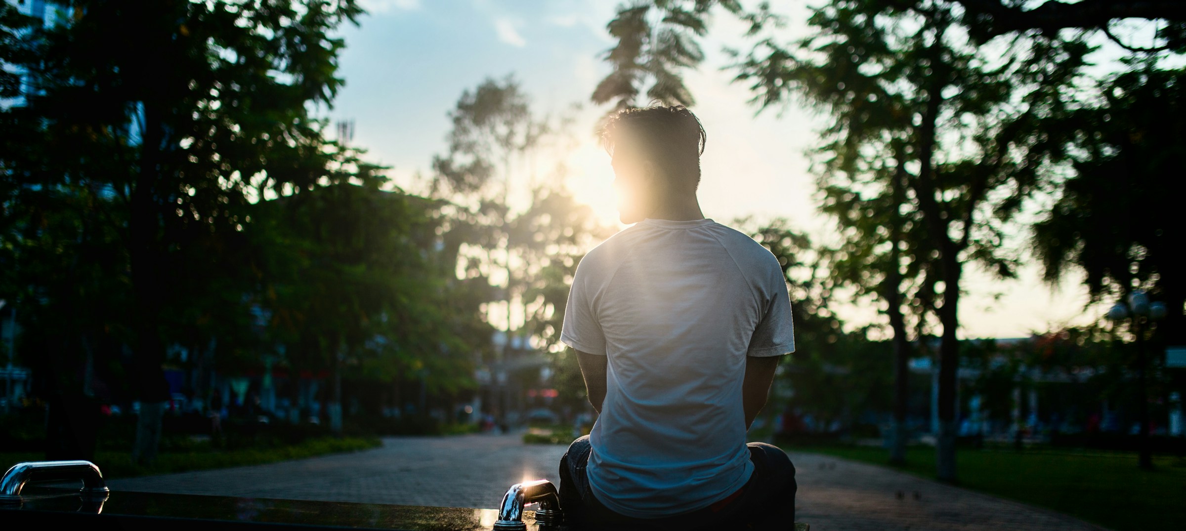 man sitting alone - Benefits of Sunlight for Skin