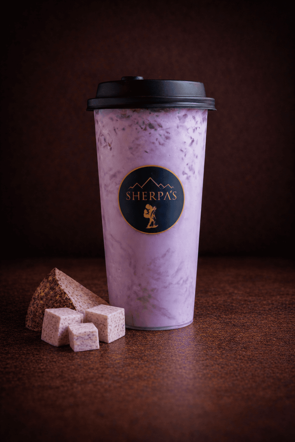 Taro Milk Tea with taro pieces and tapioca pearls at Café Sherpa's, Brookfield WI. Creamy, nutty, and smooth black tea with non-dairy creamer and condensed milk.