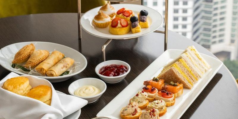 High tea with a mix of Malaysian food like curry puffs and rolls