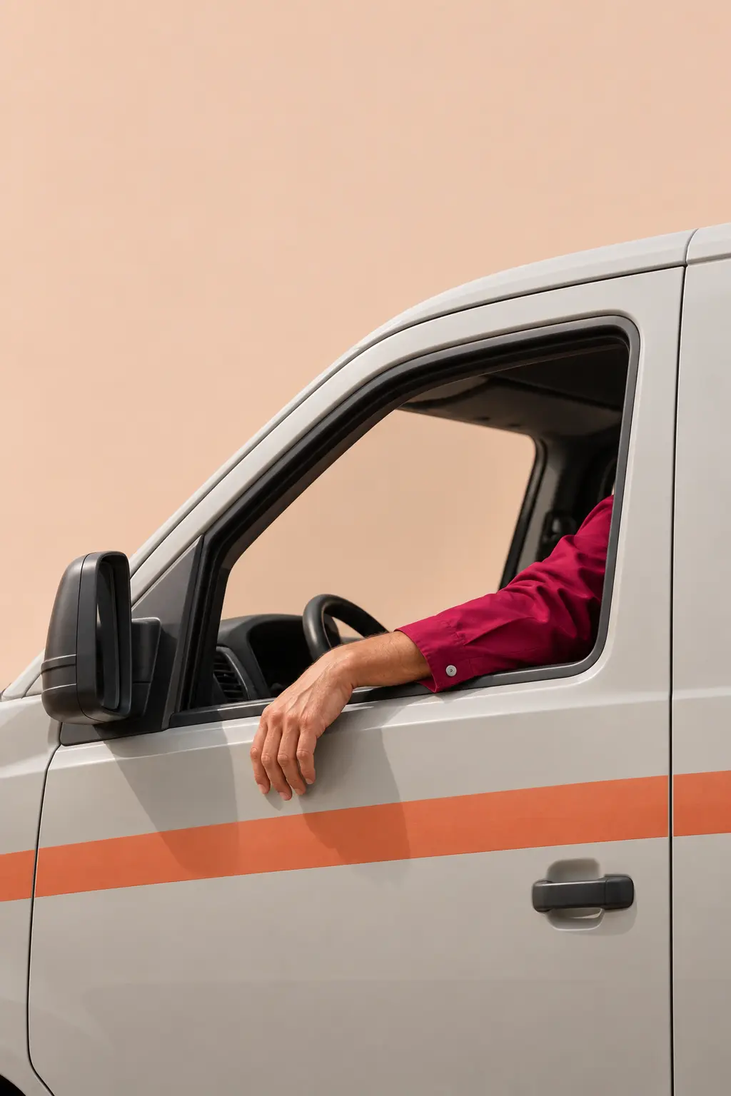 Technician's arm resting on the open window of a grey service van