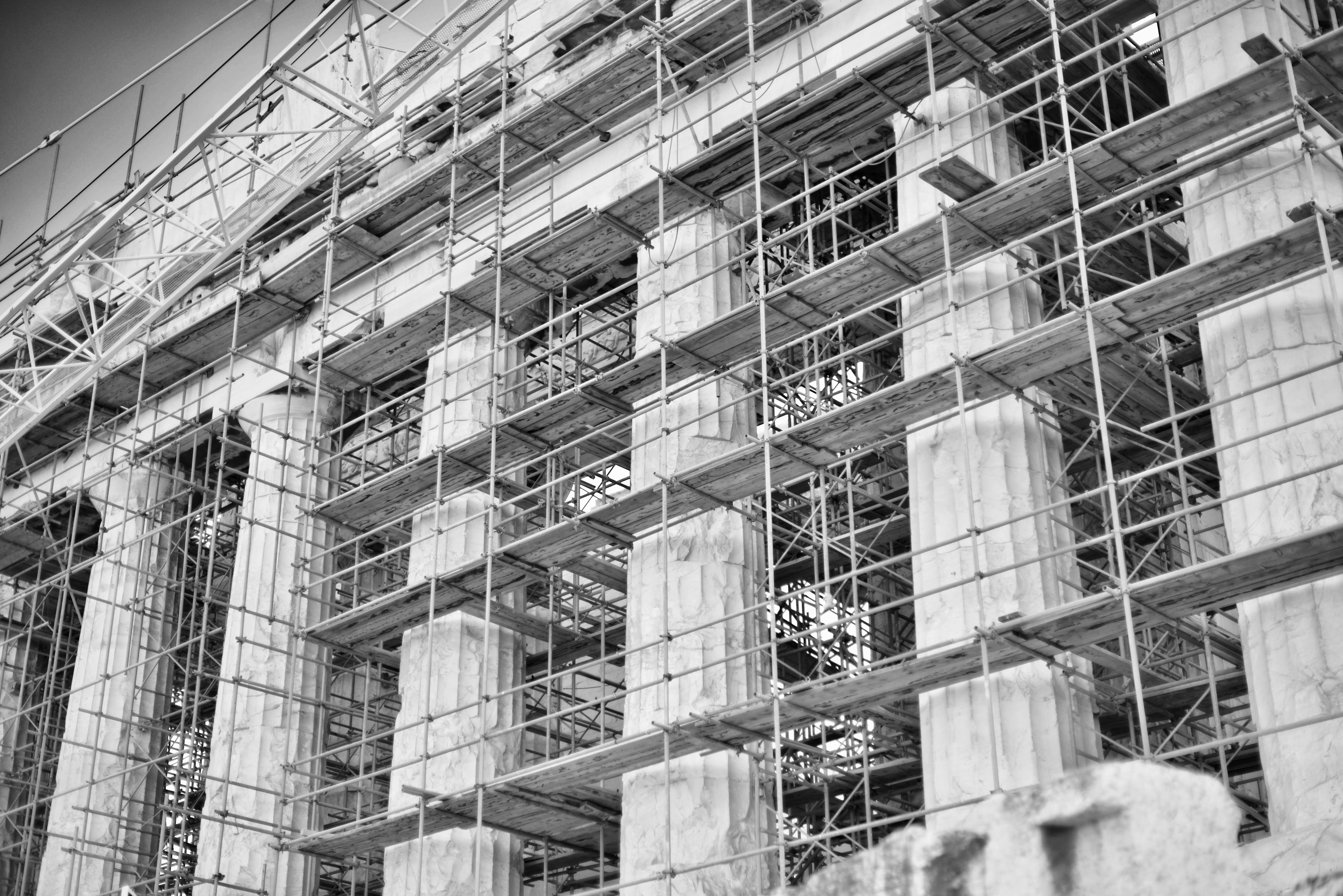 The pillars of the Parthenon in Athens, Greece, covered in scaffolding.