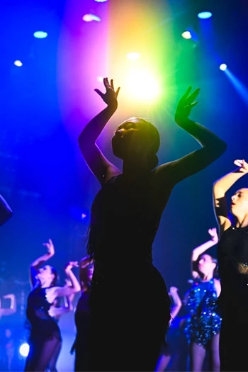 Dancer on stage under spotlights