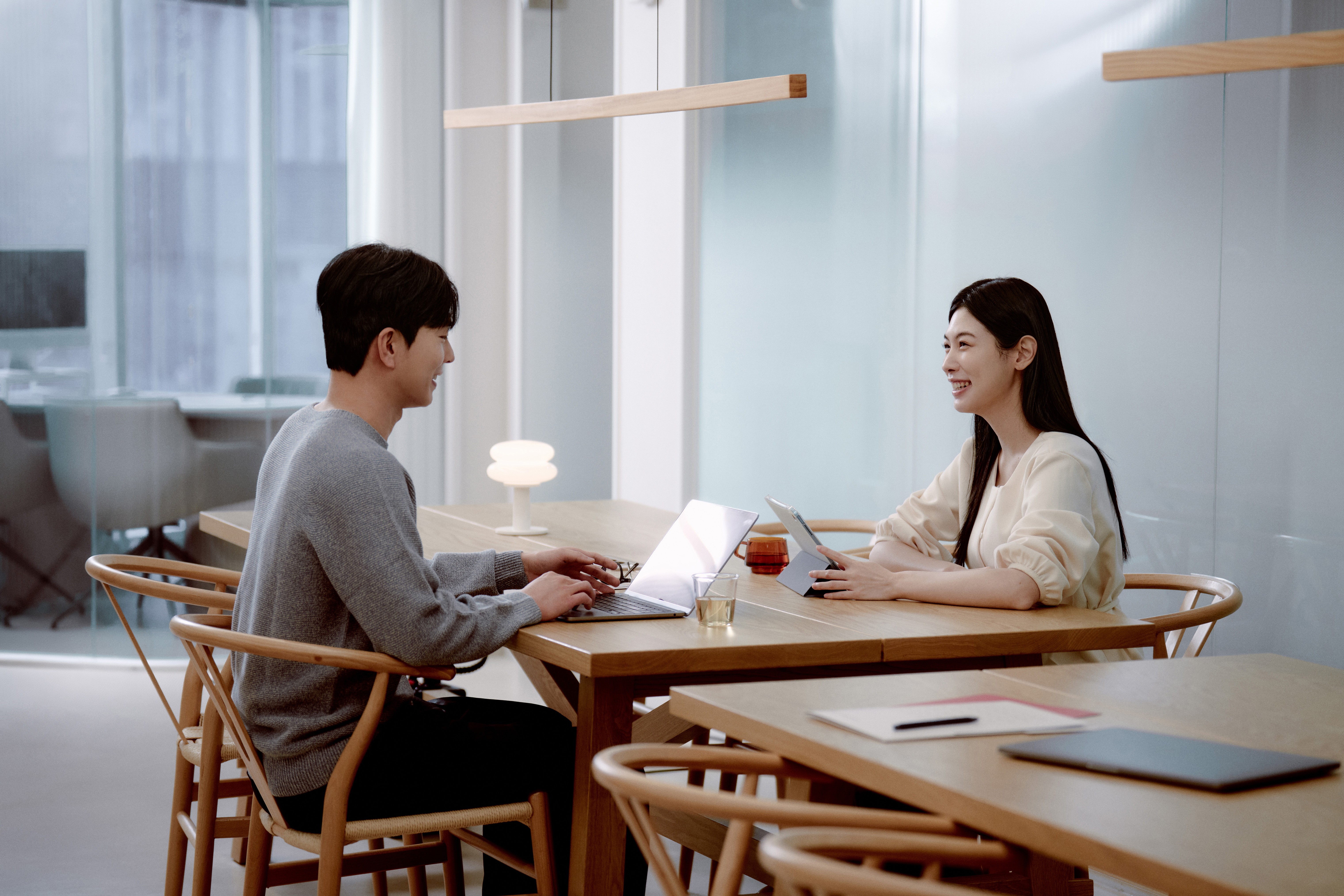 Two students smiling during a language learning session at 612 Academy, reflecting an engaging and human-centered learning experience.