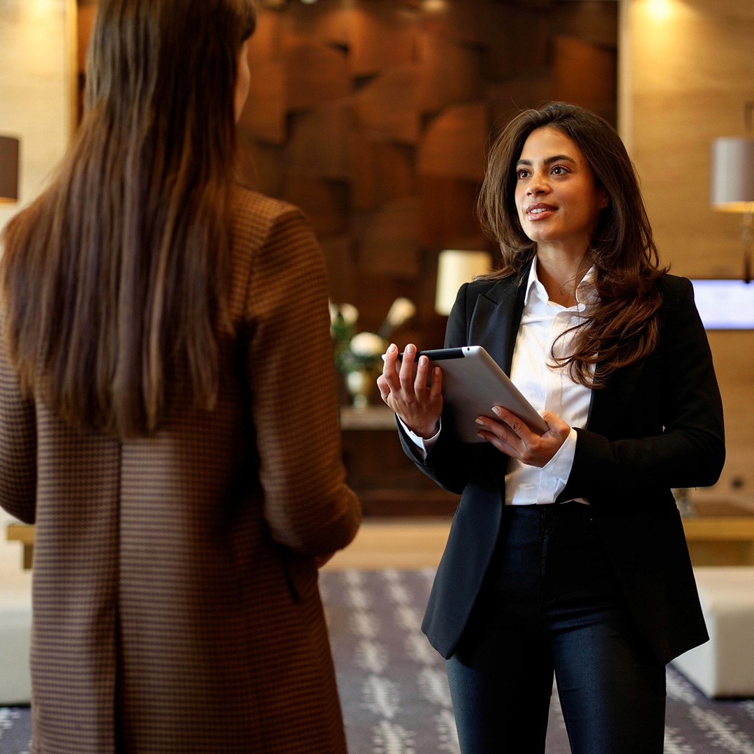 Image of front-of-house security professional at a reception greeting others