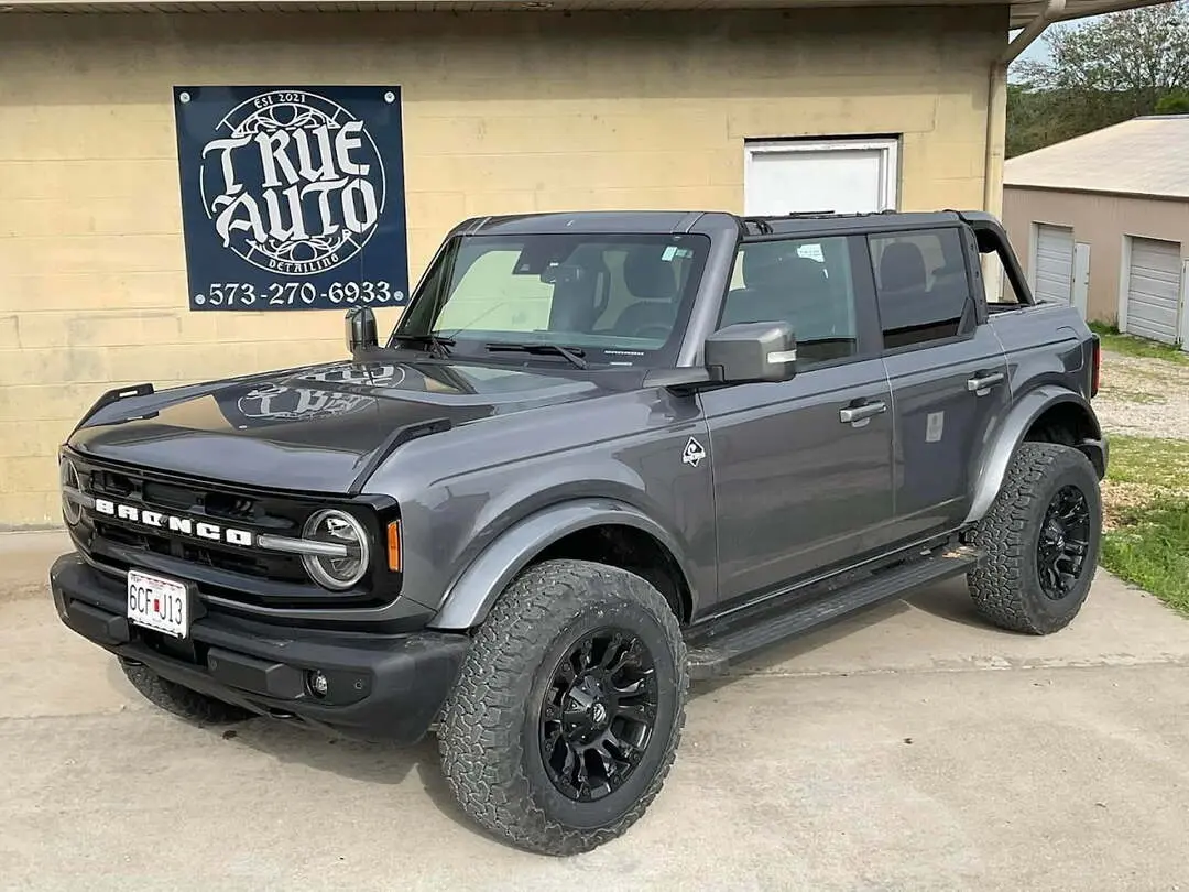 Large gray car outside on a sunny day