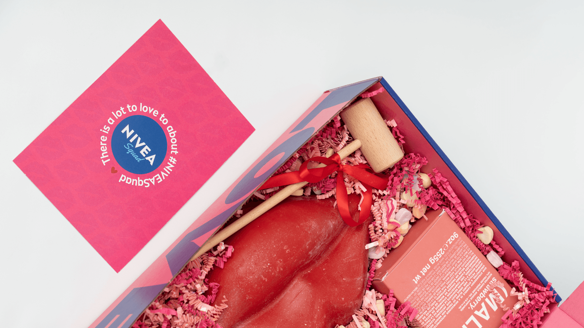 A notecard next to a custom nivea mailer for valentines day