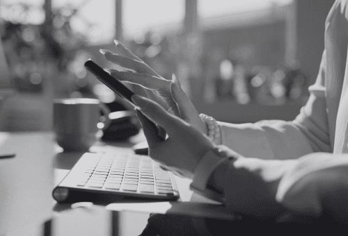 person using both laptop and smartphone