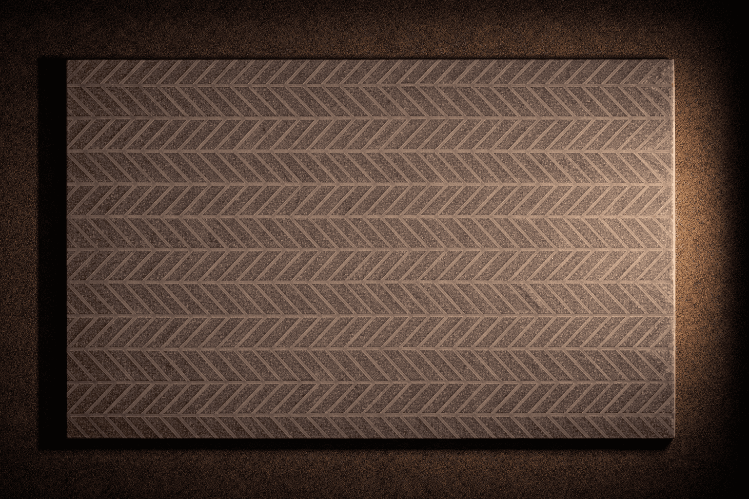 Herring bone stone cladding used in feature wall with warm lighting highlighting zigzag textured pattern