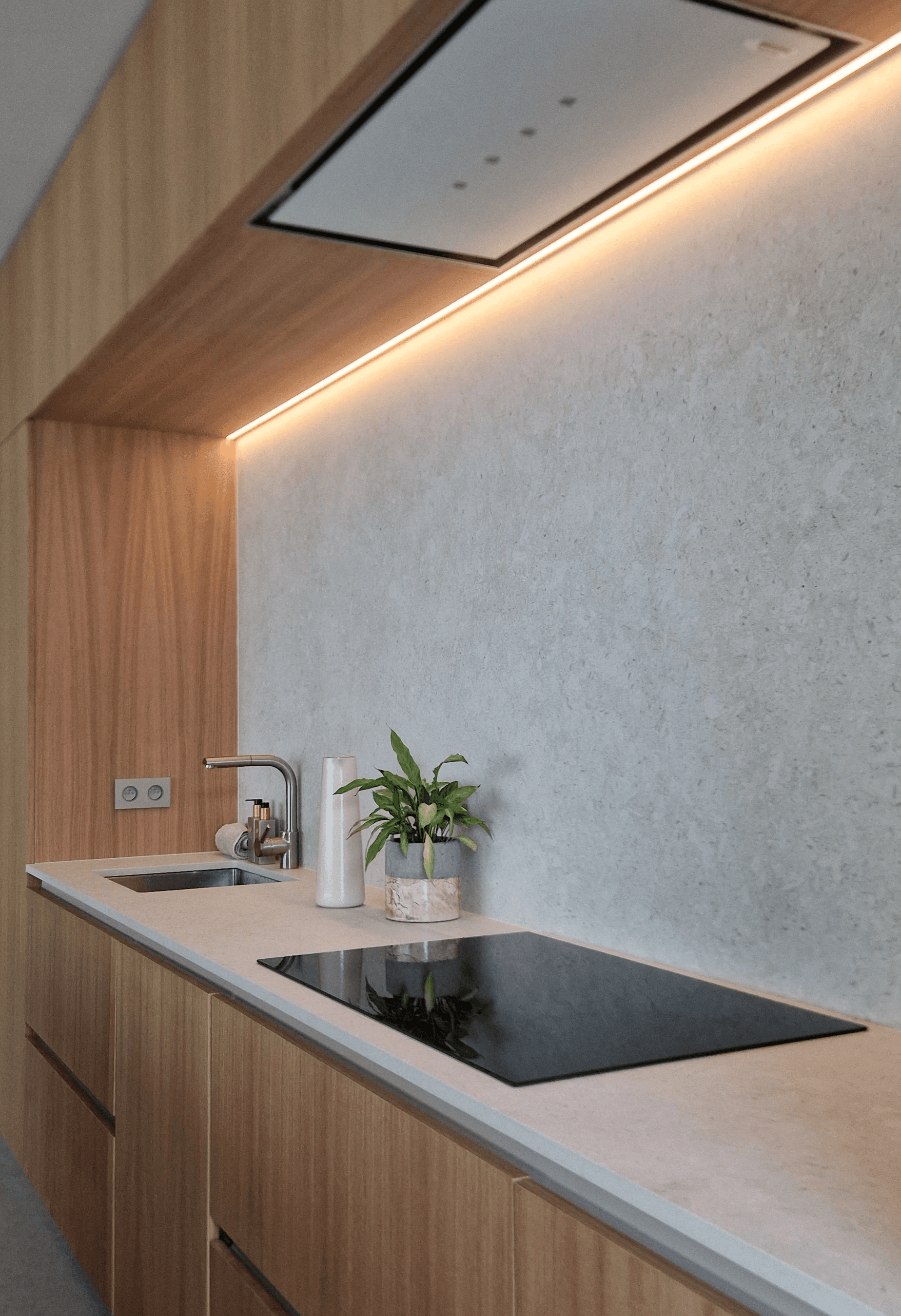 Integrated oak kitchen with concealed lighting and minimalist detailing