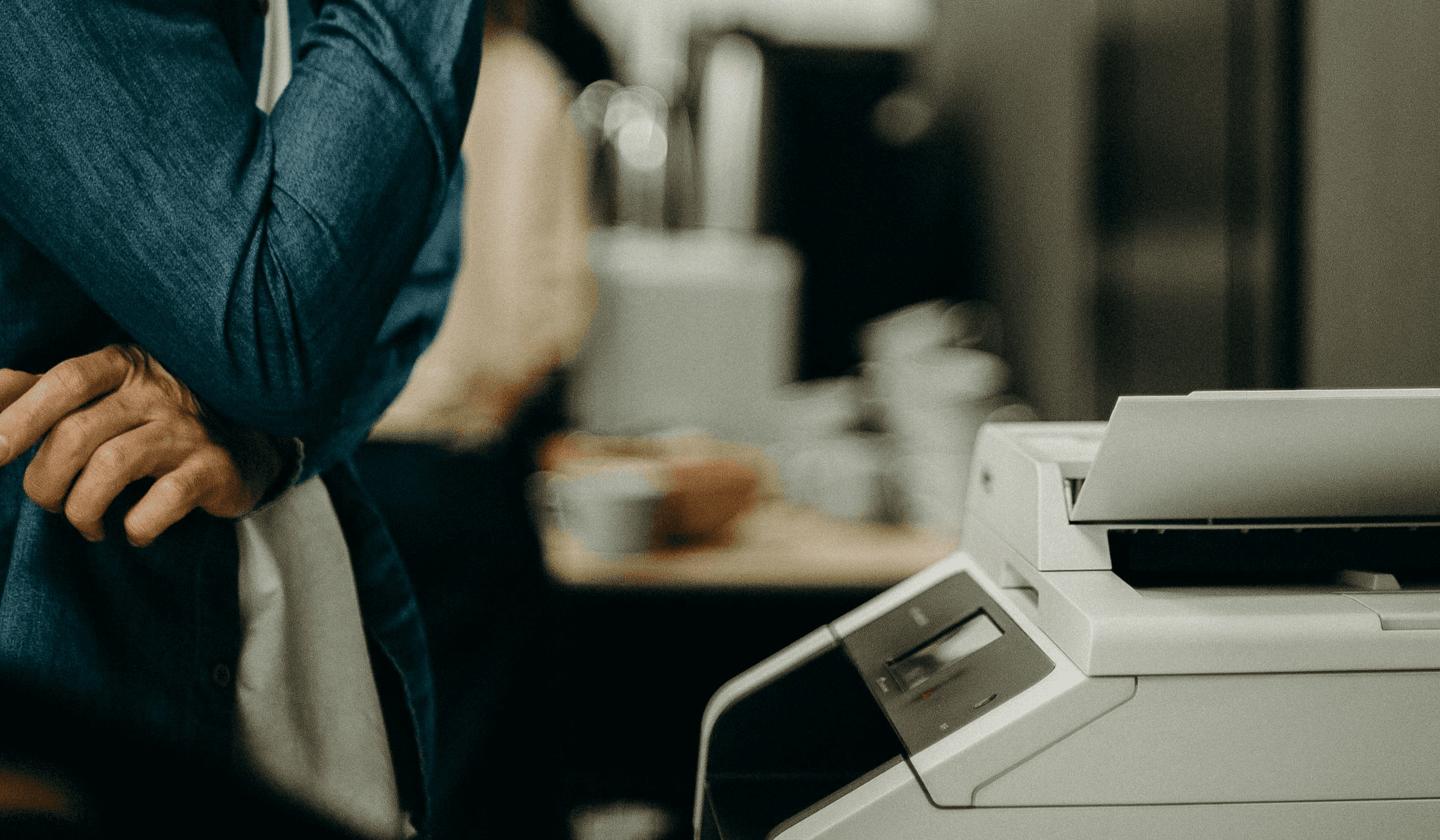 A smiling woman doctor is sitting at her desk and looking at a computer screen showing a medical screening test.