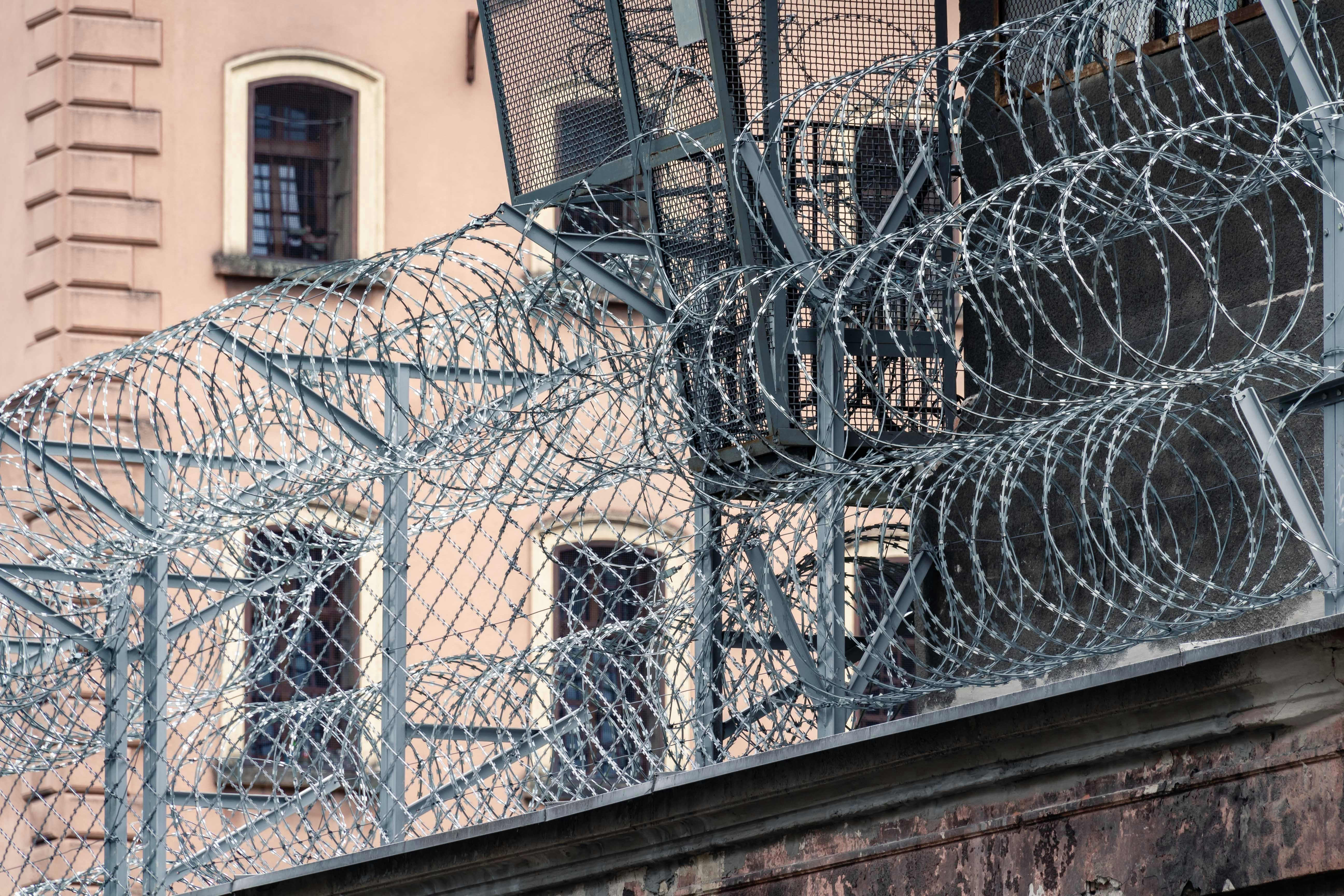 gray barbwire on fence near building during day