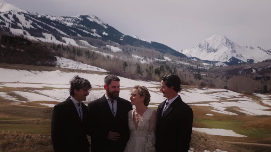 Bridal party group portrait at Pine Creek Cookhouse Ashcroft with snowcapped mountains and winter landscape