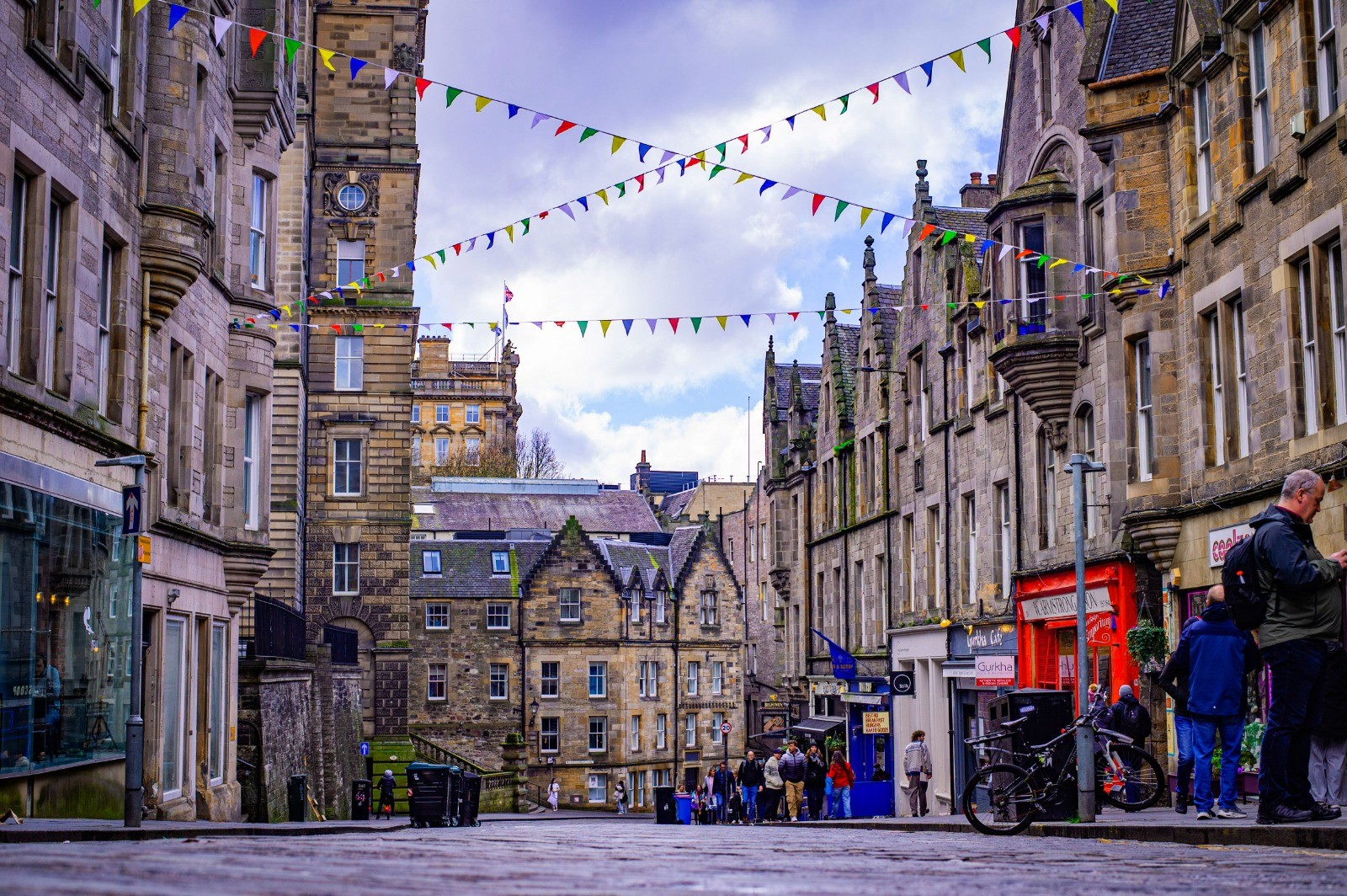 Colourful bunting over a cobblestone street in Edinburgh