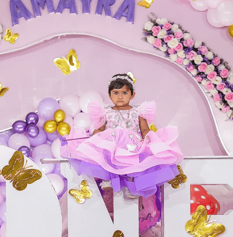 Full moon visible through silhouetted palm fronds at night.