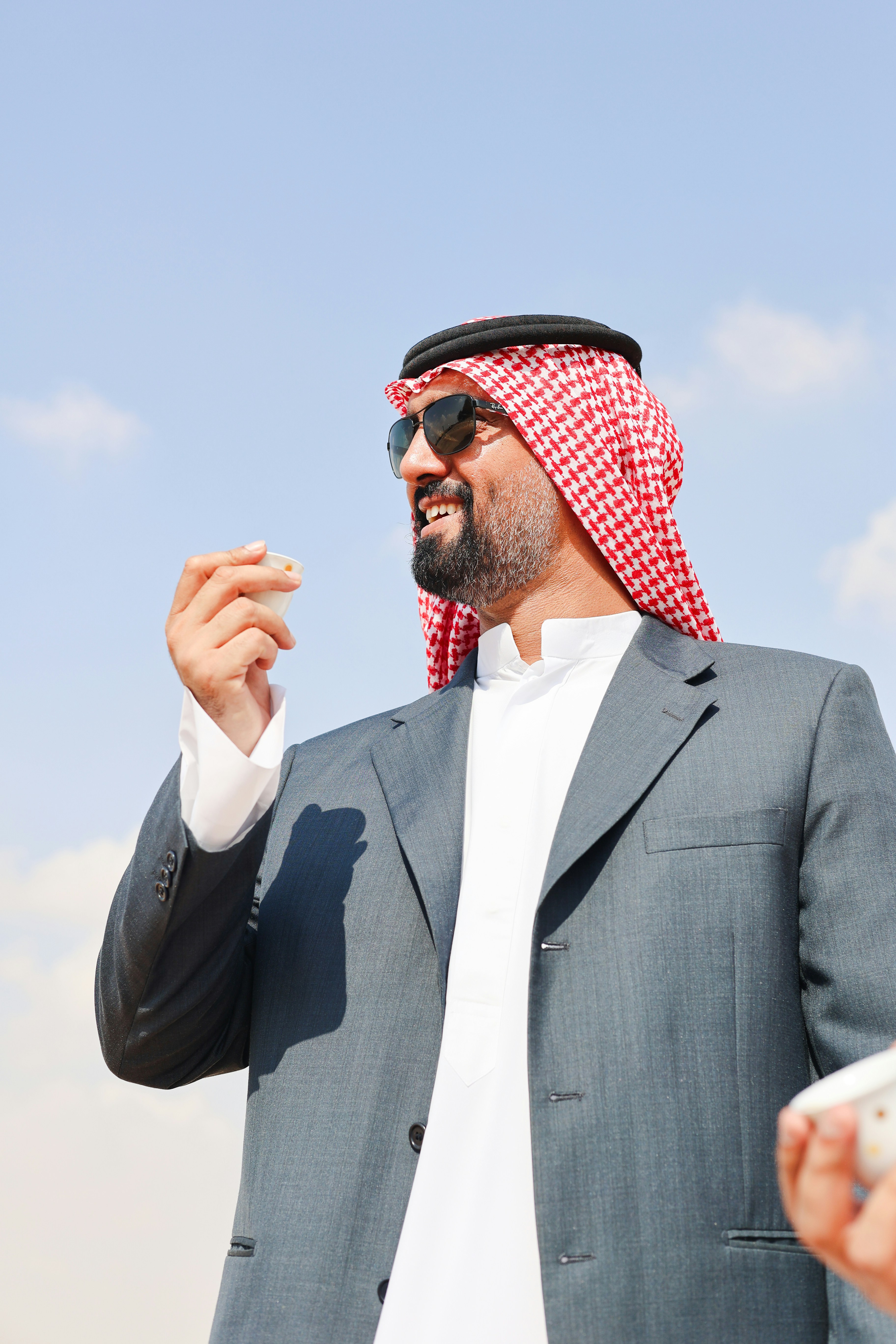 A man in a suit smoking a cigarette
