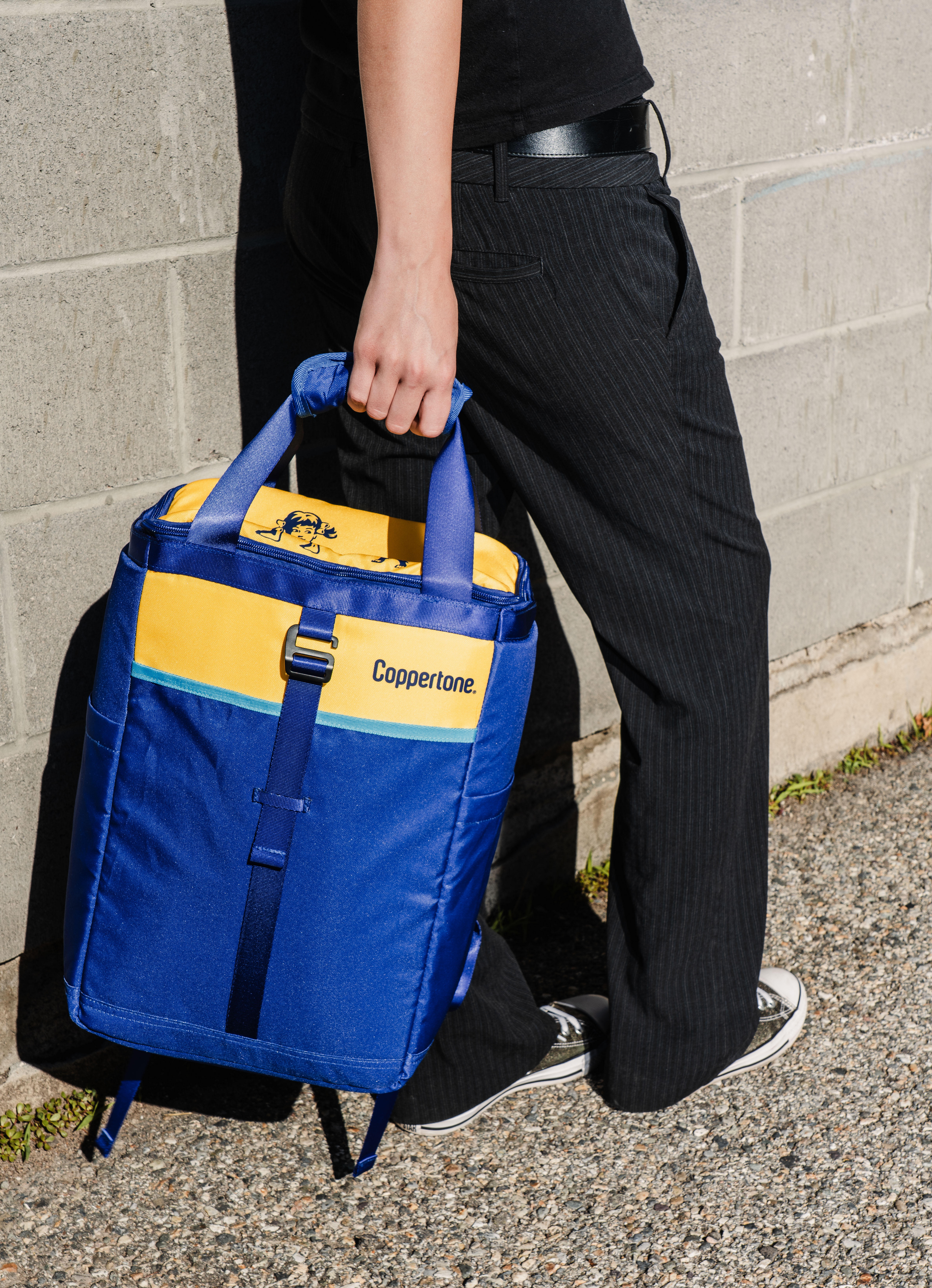 Someone holding the Explore Cooler bag and walking away from the camera.