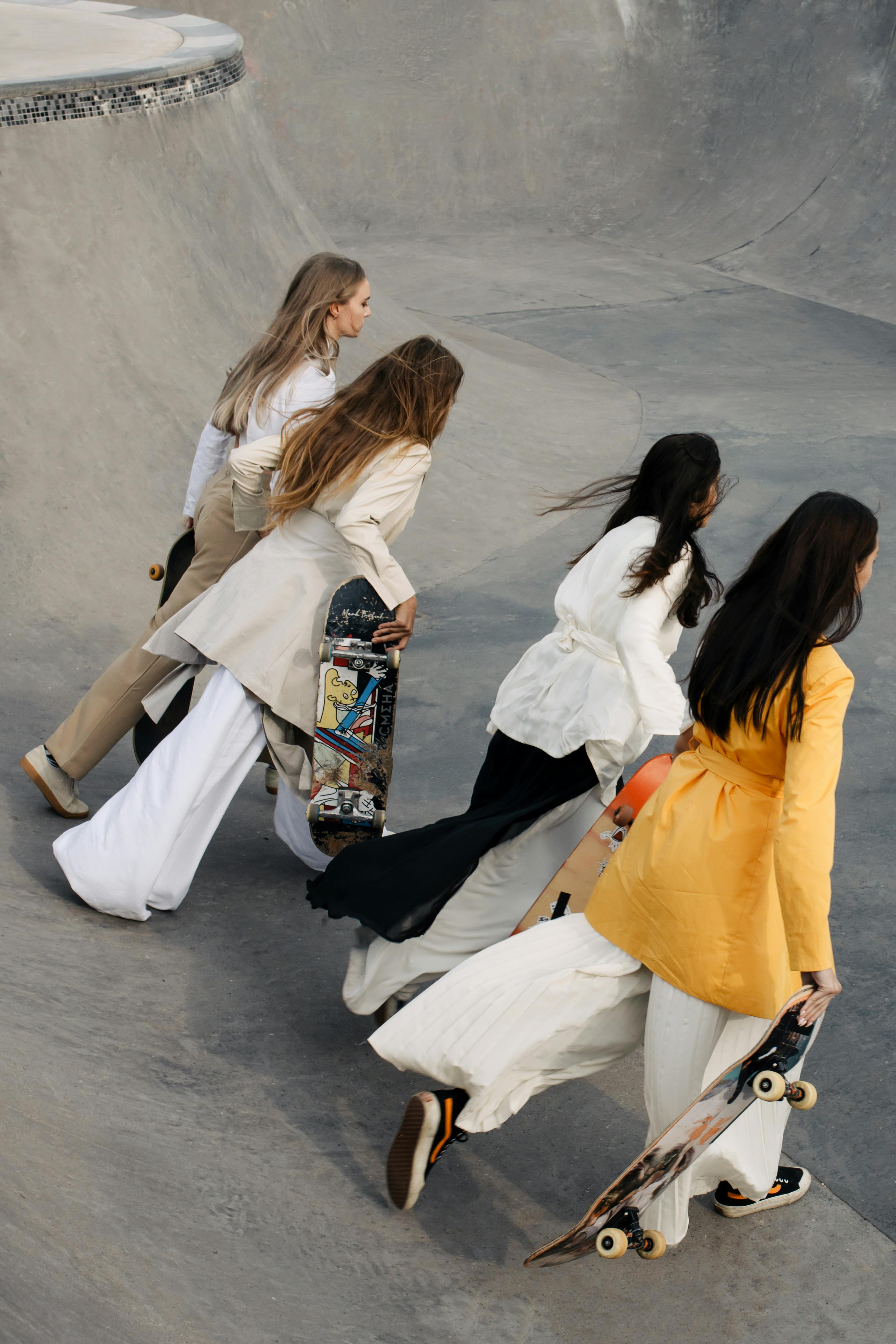 Four girls running with skateboards