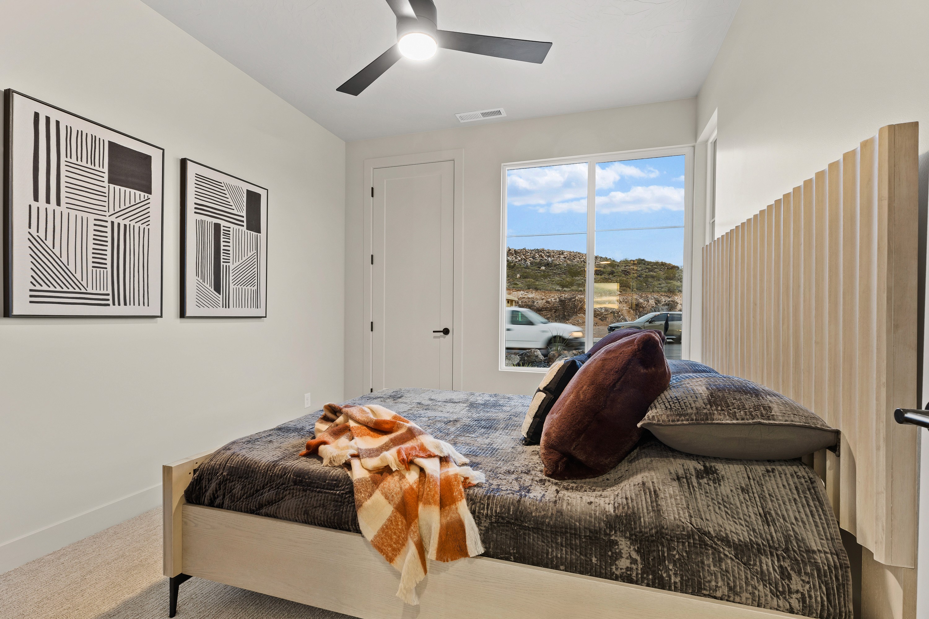 Bedroom inside The Painted Horizon twin home in Hurricane, Utah featuring bright natural light and a comfortable layout.