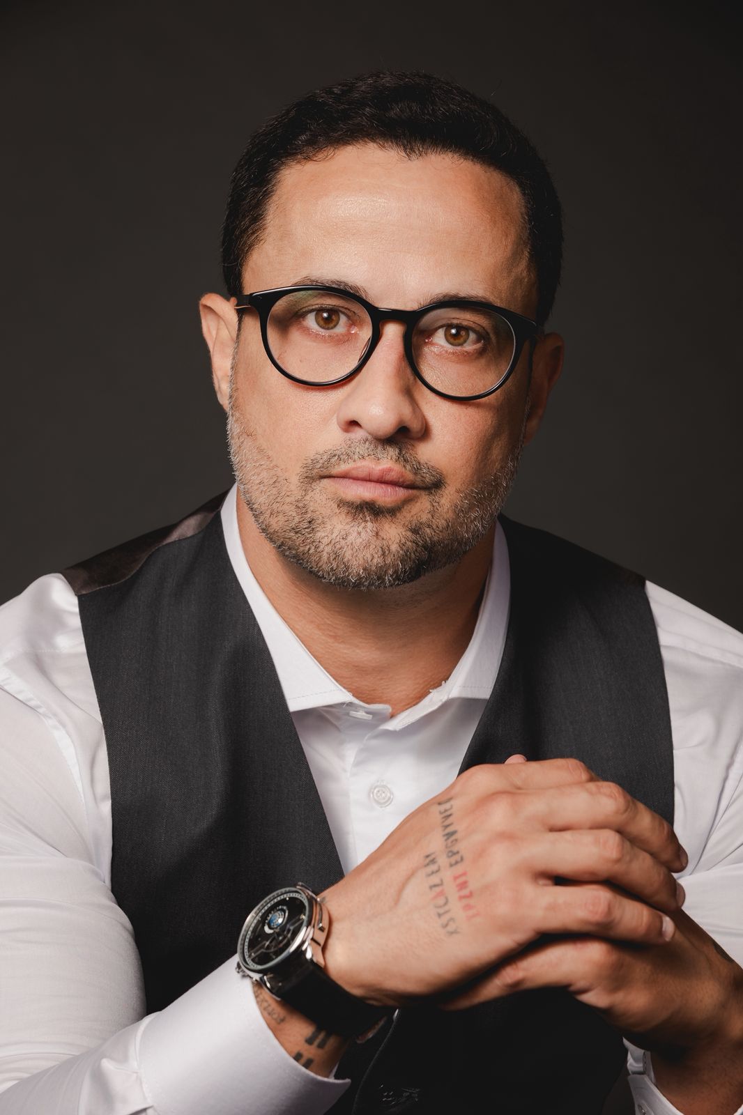 Closeup of woman wearing gold sweater typing on MacBook Pro