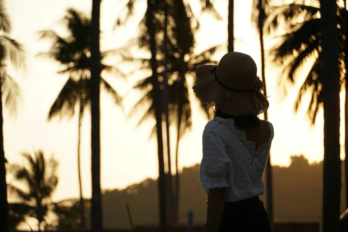 a woman in a red dress swinging from a rope
