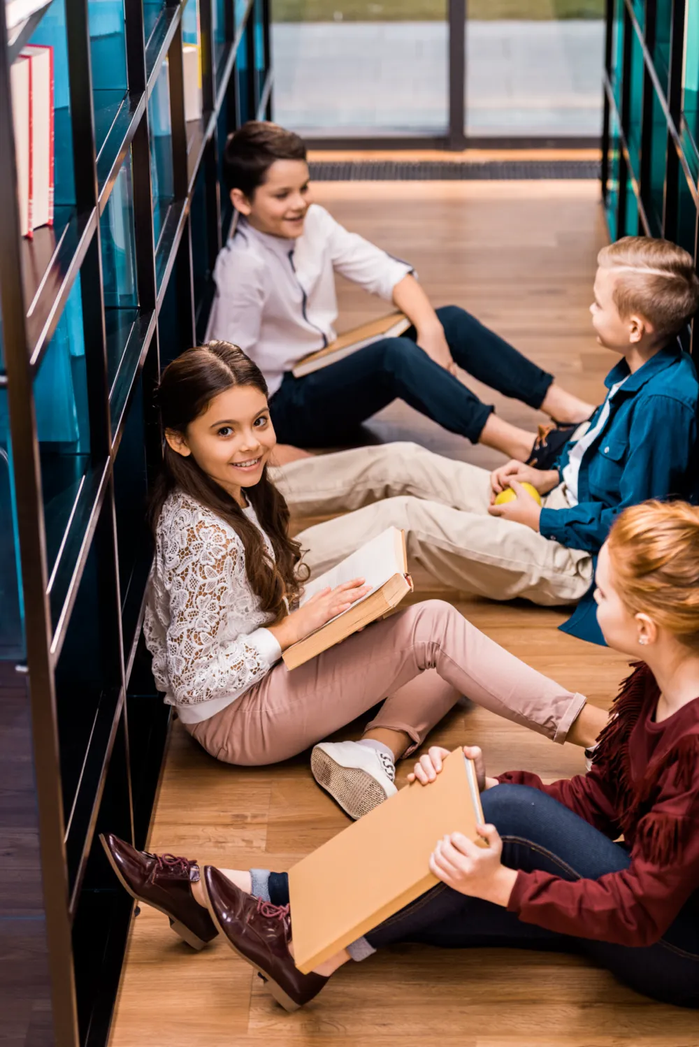 Children sat talking and reading in a library