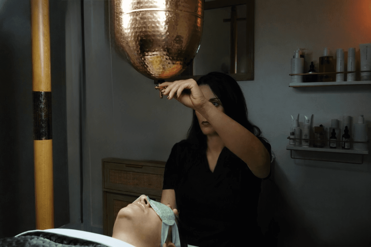 WOman pouring hot oil on client